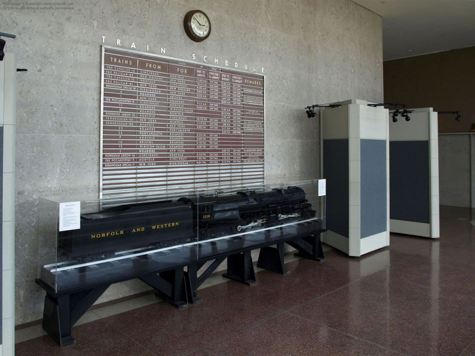 The train schedule board above the model has been set to 3rd June 1956 